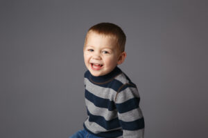 Smiling little boy wearing a striped shirt