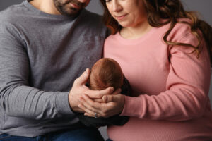 Close up of baby in mom and dad's hands