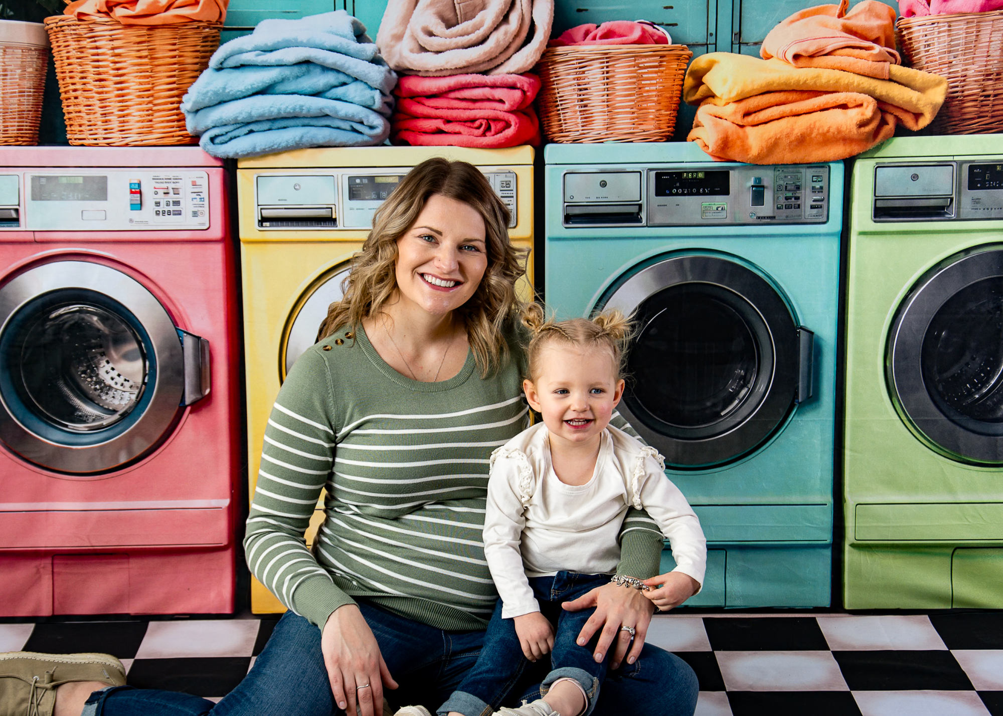 Image of a mom and daughter posing on a laundromat themed background for mom and me photo mini-session