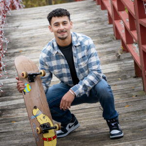 Senior with his skateboard as a prop for senior portrait