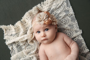 Portrait of a Newborn Baby laying on a lace blanket