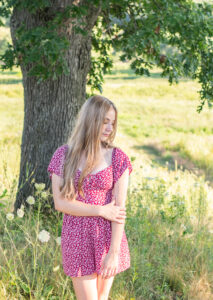 High school senior girl near a tree at Three Waters Reserve in Brodhead.