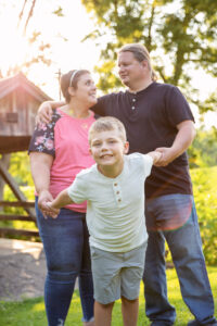 Photo of a boy with parents in the background at Beckman Mills in Beloit. 