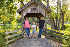 Family Photos on a bridge in the park photographed by Life in Pink Photography in Beloit, Wisconsin. 