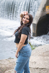 Senior Portrait of a seventeen year old girl posing near the water fall at Beckman Mills in Beloit, Wisconsin.