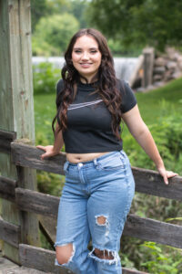 Portrait of a High School Senior posing on the footbridge at Beckman Mills.