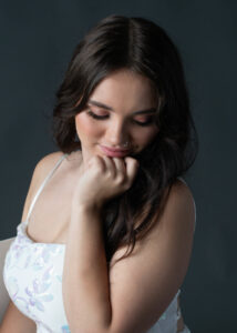 Close up pose of a high school senior taken in the studio at Life in Pink Photography.