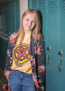 High school senior by school lockers.