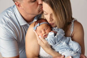 Closeup portrait of a new mom and dad holding their baby during a newborn session