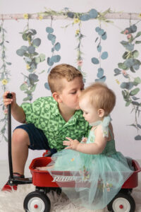 Sibling photo taking during a milestone photo session of brother and sister.