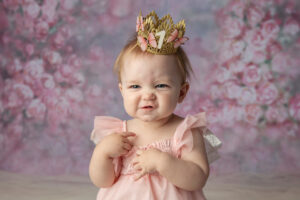 Cute milestone photo of a one year old girl with a cute expression. 