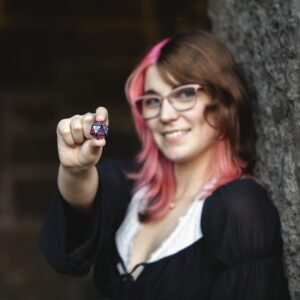 Senior pictures of High school girl with a Dungeons and Dragons game piece.  