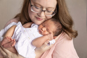 Portrait of a young mother with her newborn baby.